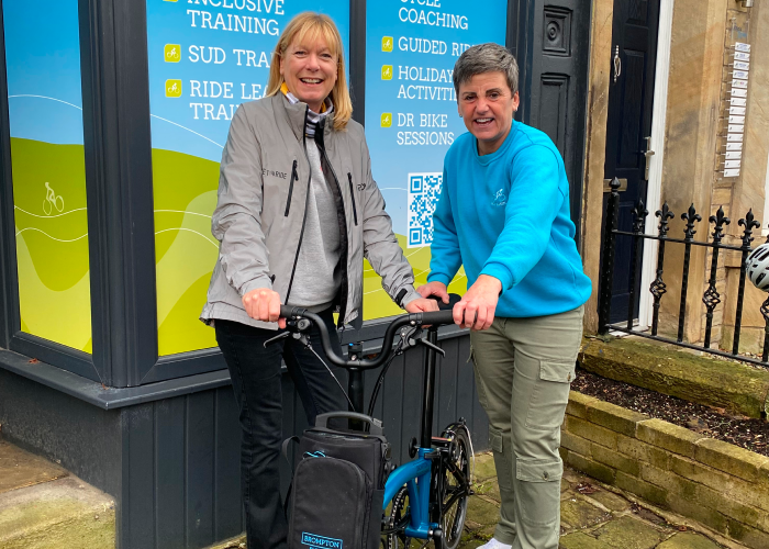 Two woman who have just won a bike