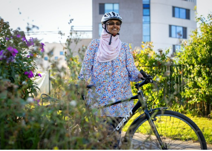 A woman standing next to a bike