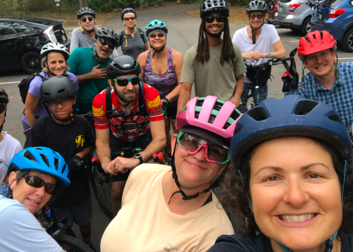 A group of people standing with bikes