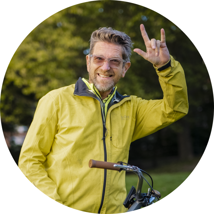 Man with green jacket on a bike