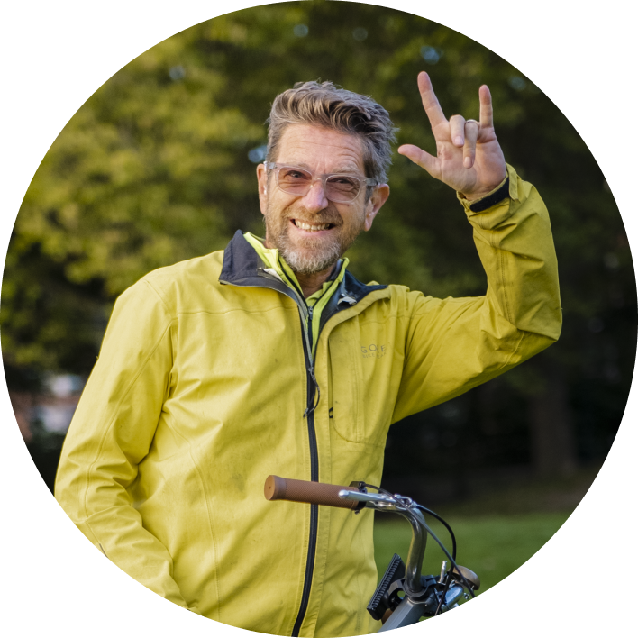 Man with green jacket on a bike